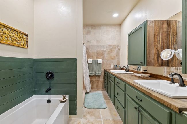 Primary Bathroom with Tub & Walk-in Shower on main level. | Image 11
