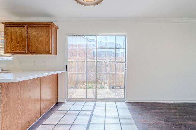 Unfurnished dining area featuring wood finished floors and crown molding | Image 11