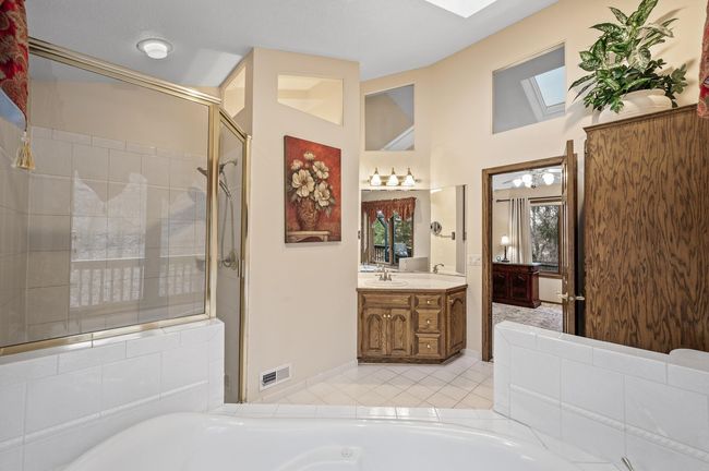 A nice size primary bathroom with a skylight for beautiful natural light | Image 26