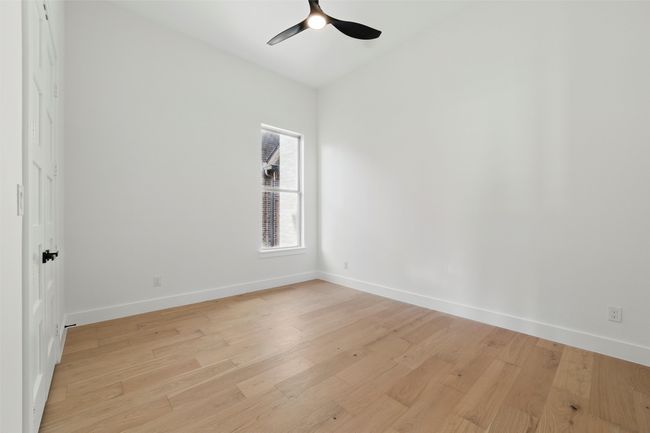 Empty room with baseboards, light wood-type flooring, and a ceiling fan | Image 22