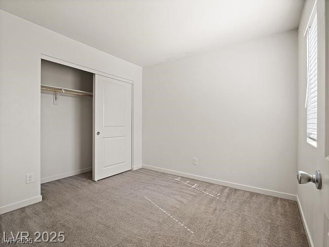 Unfurnished bedroom featuring light carpet, multiple windows, and a closet | Image 17
