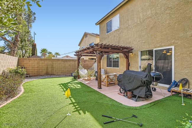 View of yard with a pergola, fence, and a patio | Image 19