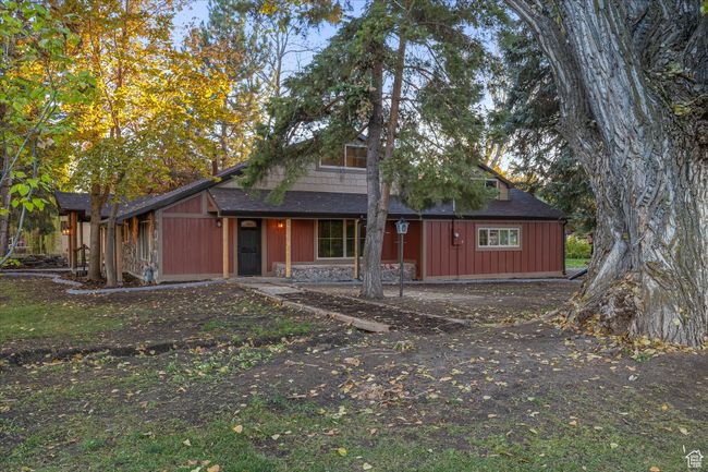 View of front of house featuring a shingled roof and stone siding | Image 8