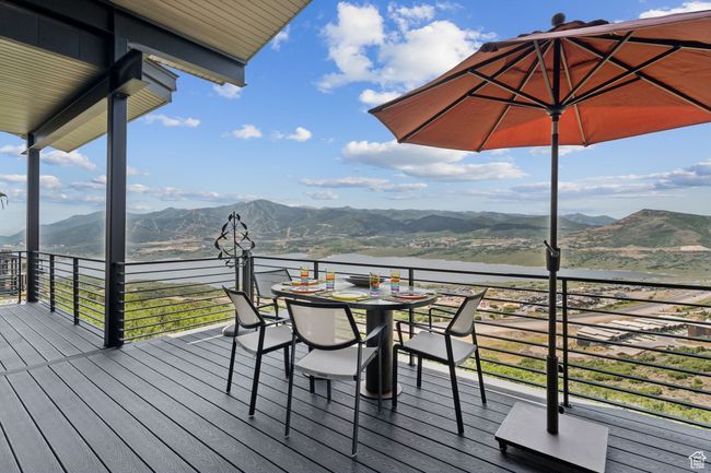 Deck with a water and mountain view and outdoor dining space | Image 46
