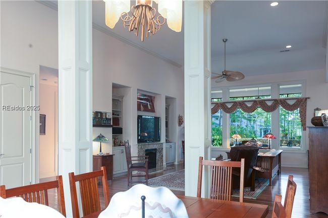 Columns provide separation of the dining area from the great room and foyer. Spacious dining area for a sideboard and China display cabinet with room to expand the table for dinner parties! | Image 15