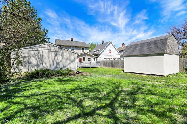 view of yard featuring an outdoor structure, fence, a deck, and a shed | Image 42