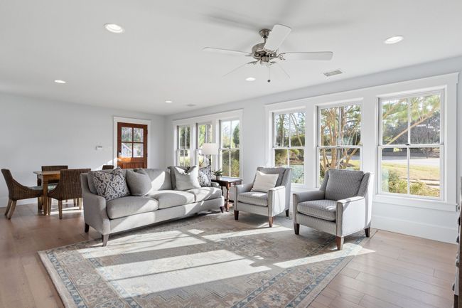 Living room with a wealth of natural light, visible vents, and light wood-style floors | Image 29