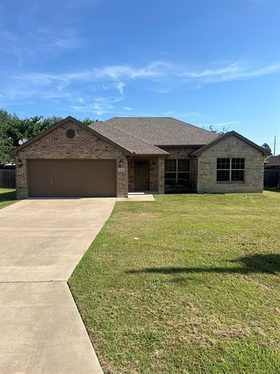 Single story home with a garage and a front lawn | Image 2