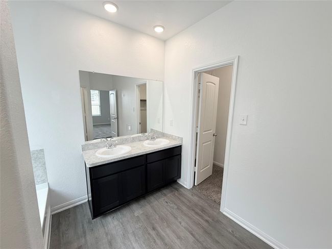 14501 SUGAR PINES DR - Primary bedroom with ensuite bathroom, dual sinks, separate tub and shower, and walk in closet | Image 28