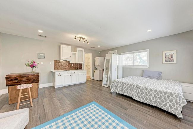 Bedroom with recessed lighting, visible vents, baseboards, and dark wood-style floors | Image 30