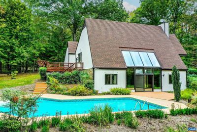 Lush landscaping designed by a Master Gardener surrounds a sparkling pool in this private back yard. | Image 2