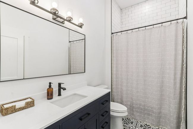 Full bathroom featuring vanity, tile patterned floors, and a shower with shower curtain | Image 20