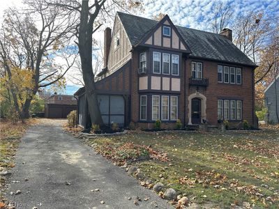 Tudor house featuring a front yard and a garage | Image 2