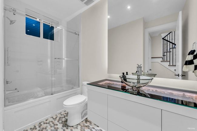 Full bathroom with recessed lighting, combined bath / shower with glass door, toilet, vanity, and visible vents | Image 21