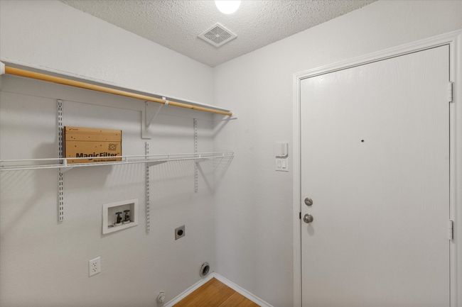 Laundry room with washer hookup, hookup for an electric dryer, and wood finished floors | Image 21