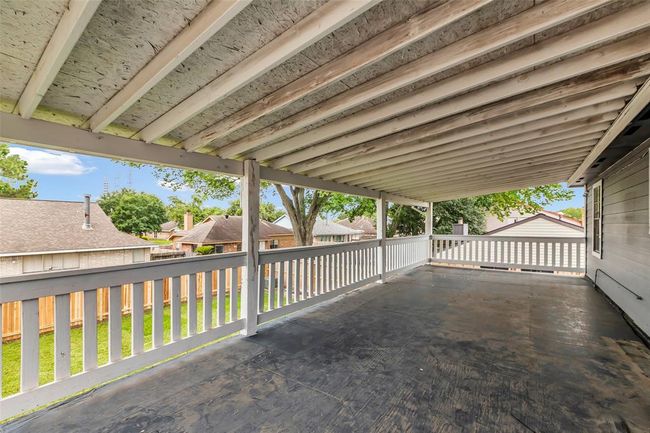 A spacious balcony on the second floor with views of the backyard and surrounding neighborhood. | Image 24