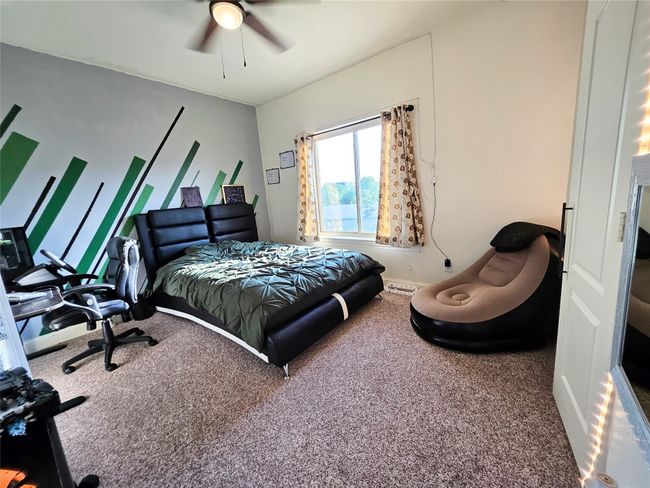 Carpeted bedroom featuring a ceiling fan and baseboards | Image 31