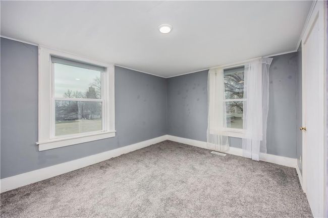 Carpeted spare room with plenty of natural light, visible vents, and baseboards | Image 45