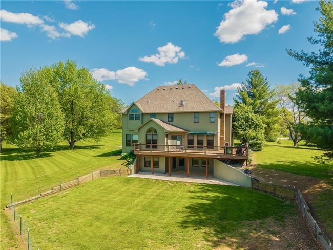 Rear view of property featuring a lawn, a patio, a fenced backyard, and a wooden deck | Image 4