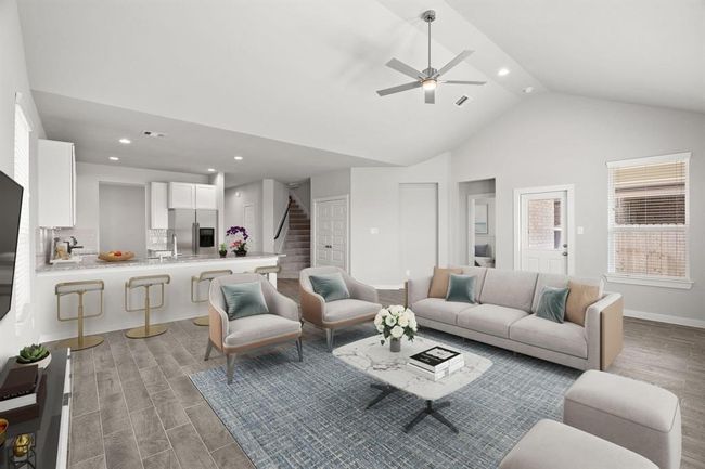 Bring your loved ones and guests together in the inviting living room! Boasting lofty high ceilings, recessed lighting, a stylish ceiling fan, custom paint, stunning flooring, and expansive windows that flood the space with ample natural light all day long. | Image 18