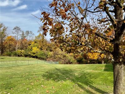 An absolutely gorgeous double lot with extensive green lawn and a private wooded back yard. | Image 2