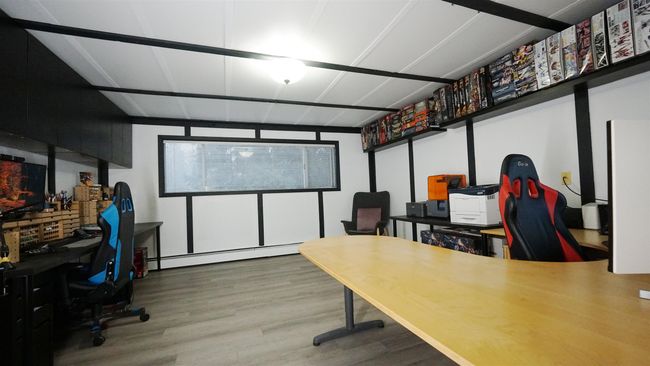 Home office featuring a baseboard heating unit and wood finished floors | Image 14