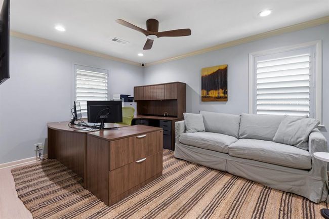 Bedroom # 2 features refinished wood floors, recessed lights, window shutters and modern ceiling fan. | Image 13