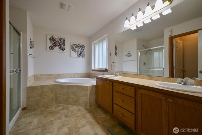 Primary bathroom, double sinks, soaking tub with surround tile, stand alone shower, potty room. | Image 26