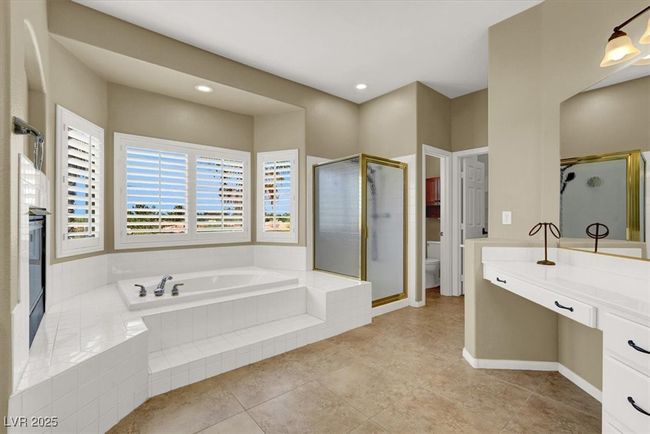 Bathroom featuring a bath, a shower stall, vanity, and tile patterned floors | Image 26