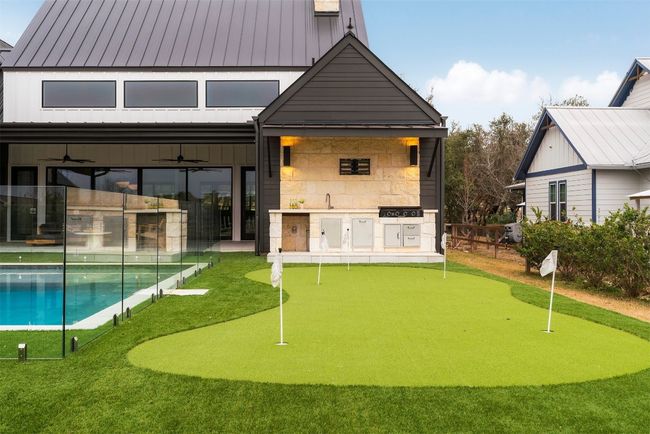 A five-hole putting green awaits friendly competition, while an outdoor kitchen makes alfresco dining effortless | Image 34