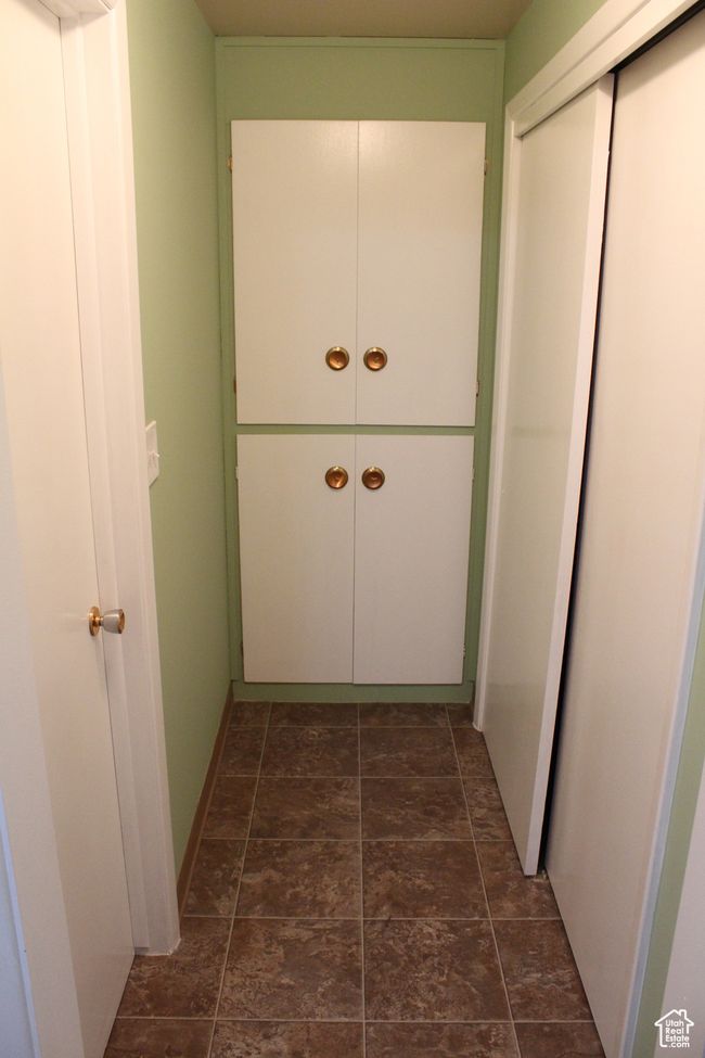 Hallway featuring dark stone finish floors | Image 24