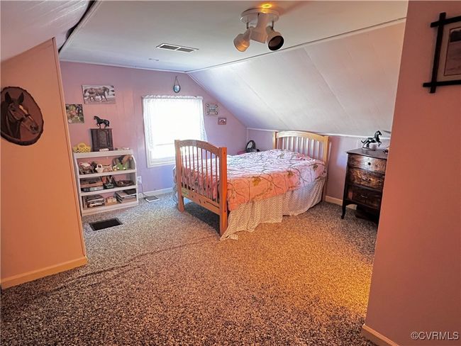Bedroom with lofted ceiling and carpet floors | Image 32