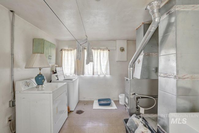 Laundry room with washing machine and clothes dryer | Image 17