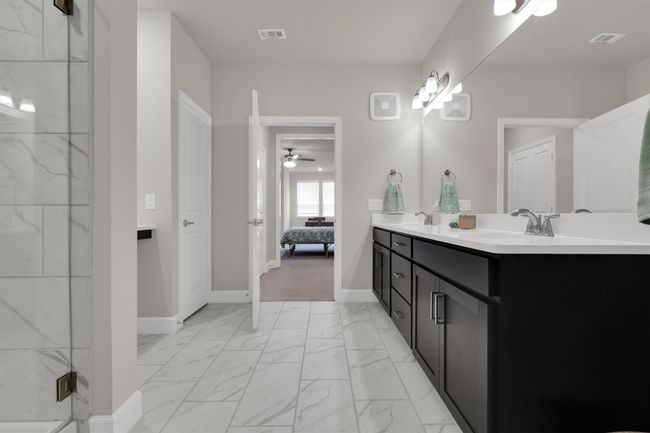 Ensuite bathroom featuring marble finish floors, double vanity, a marble finish shower | Image 24