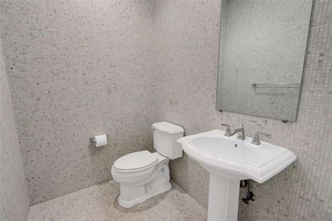 Half bath with tile walls, toilet, and tile patterned flooring | Image 21