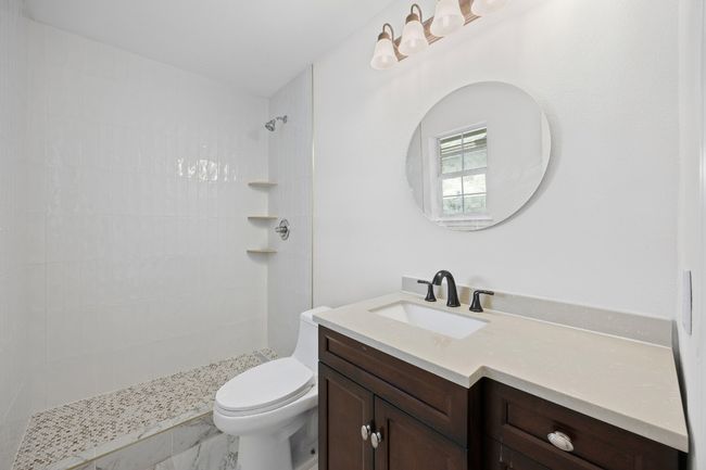 Full bathroom featuring vanity and a tile shower | Image 13