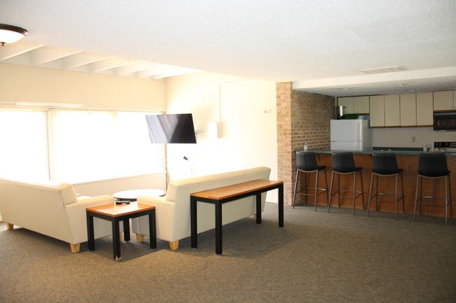 Gathering space is huge, with kitchen and "bar" area, and multiple seating areas. | Image 33