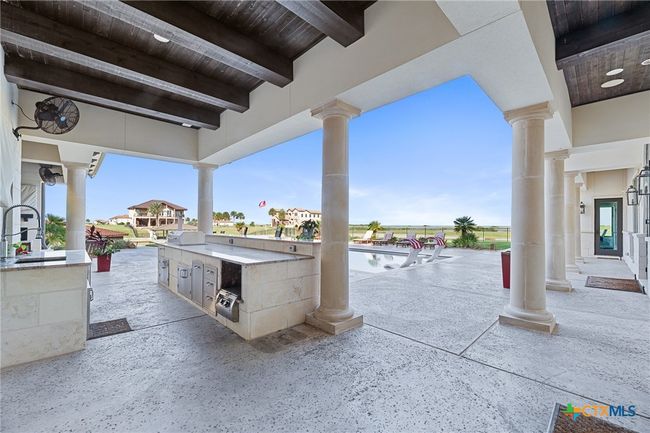 Loggia with Outdoor Kitchen and Poolside Seating Area | Image 26