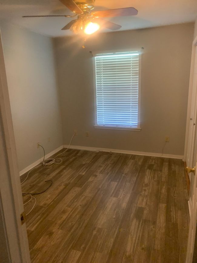 Empty room featuring ceiling fan and wood finished floors | Image 12