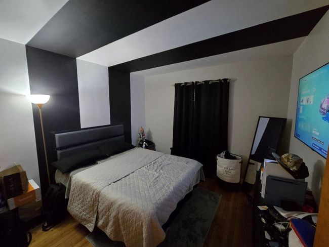 Bedroom featuring wood finished floors | Image 8