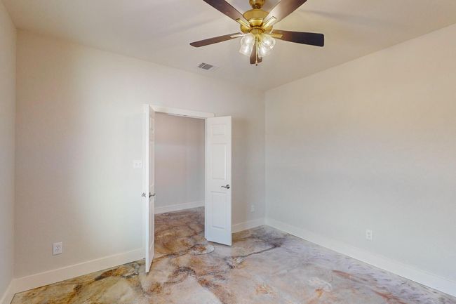 Unfurnished room with ceiling fan and concrete floors | Image 23