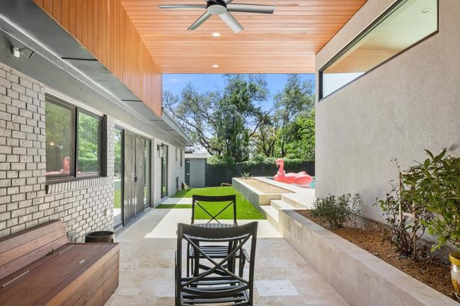 View of patio with a fenced backyard and ceiling fan | Image 29