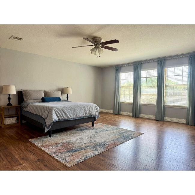Primary bedroom with ceiling fan and plenty of windows for natural light | Image 23