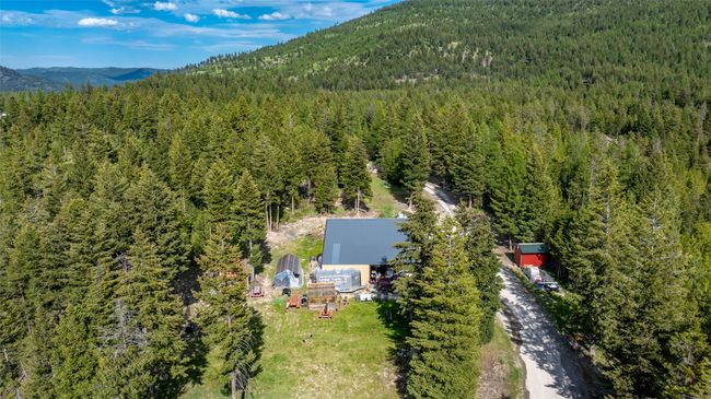 Aerial overview of property's location featuring a forest and a mountain backdrop | Image 73
