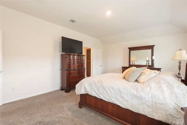 Bedroom featuring lofted ceiling and light carpet | Image 12