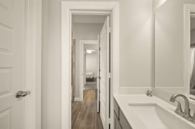 Dual vanity sink with updated fixtures in the shared upstairs bathroom, designed for convenience and comfort. | Image 35