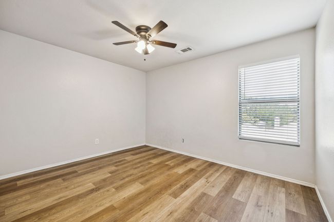 Bedroom featuring ceiling fan and light wood-type flooring | Image 23