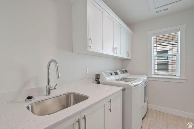 Washroom featuring separate washer and dryer and cabinet space | Image 23