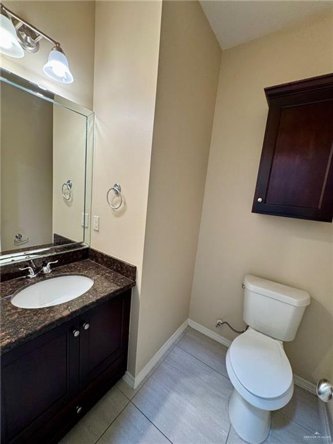 Half bathroom featuring tile patterned floors, vanity, toilet, and baseboards | Image 7