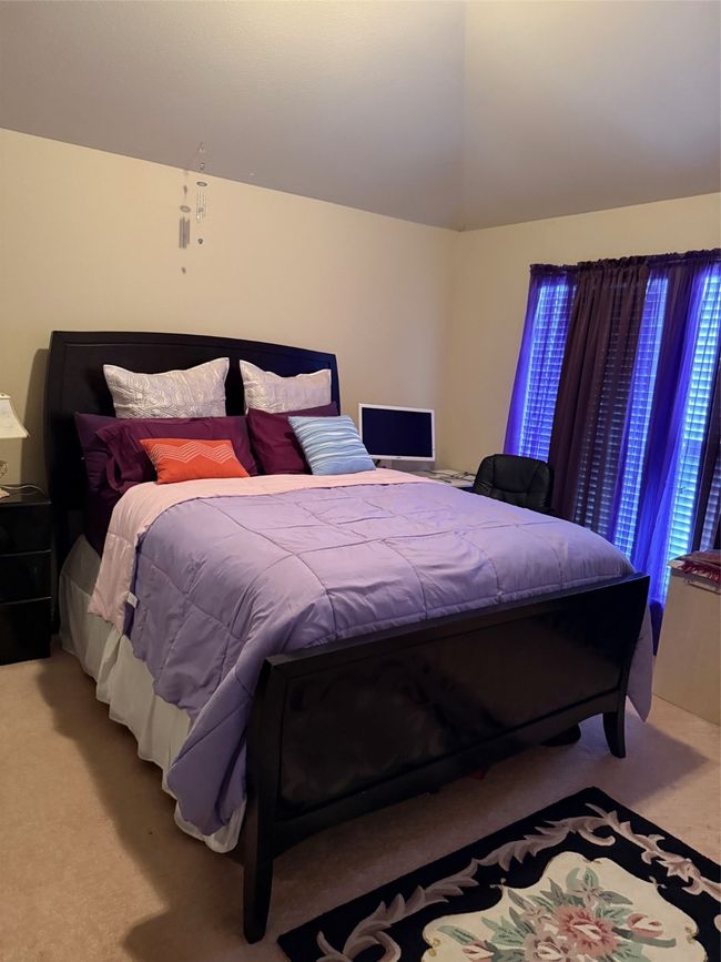 Carpeted bedroom featuring vaulted ceiling | Image 37